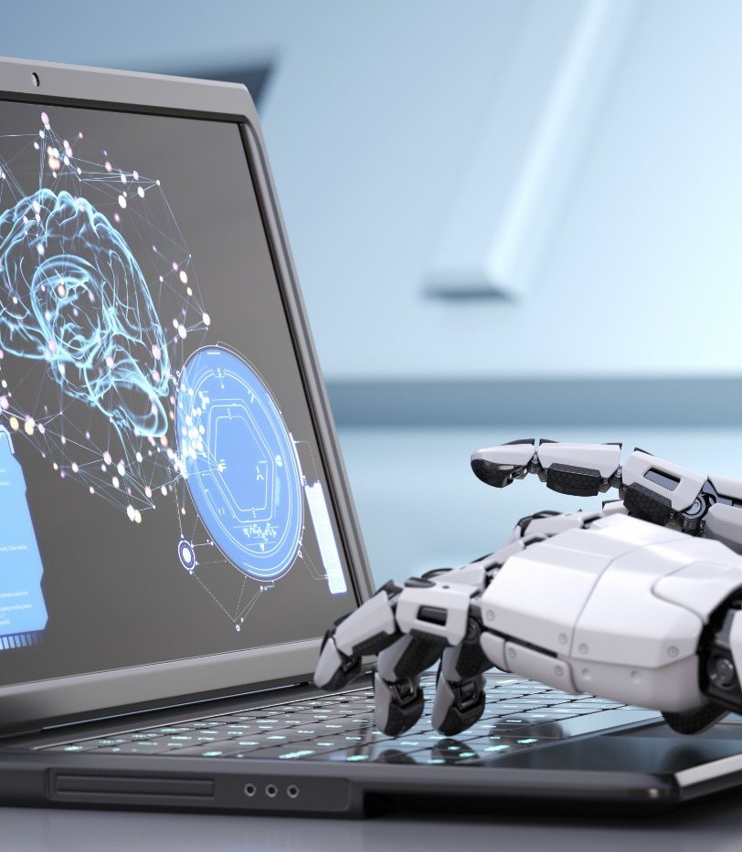 A robotic hand typing on a laptop showing a neural-network visualisation